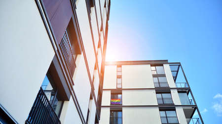 Facade of a modern apartment building. Glass surface with sunlight. Modern apartment buildings on a...