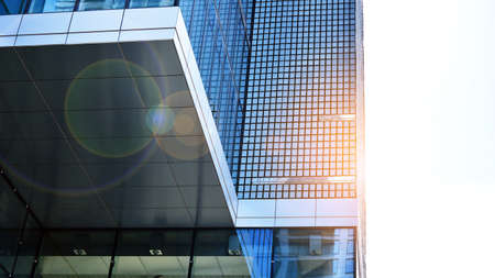 Downtown corporate business district architecture. Glass reflective office buildings against blue...