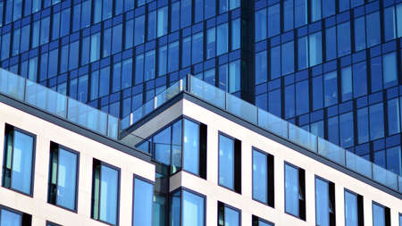 The glazed facade of an office building with reflected sky. Modern architecture buildings exterior...