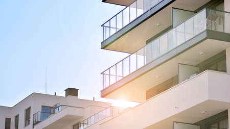 Detail of new luxury house and home complex. Glass surface with sunlight. Rising sun on the horizon....