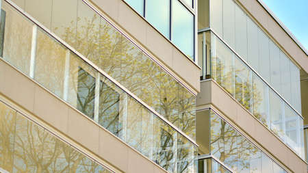 A fragment of modern architecture, walls and glass. Windows and balconies of a residential building...