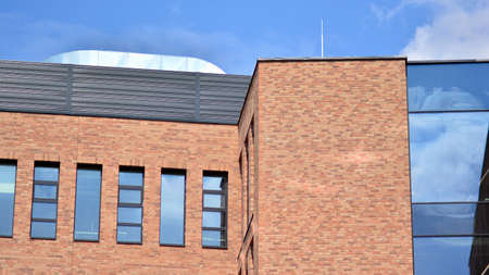 Modern brick and glass facade of the office building. A contrasting combination of sky and brick...