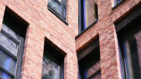 Modern brick and glass facade of the office building. A contrasting combination of sky and brick...