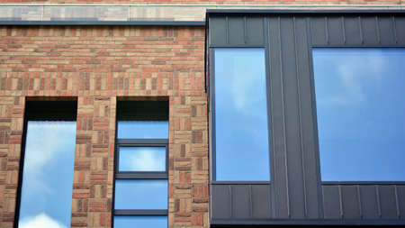 Modern brick and glass facade of the office building. A contrasting combination of sky and brick...