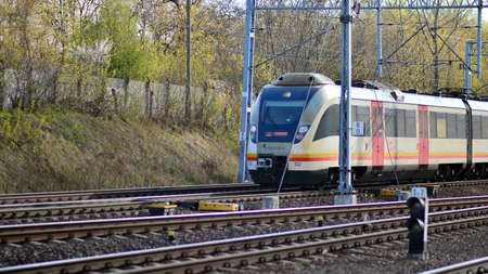 Warsaw, Poland. 26 April 2021. Passenger train of public transport on railroad track.