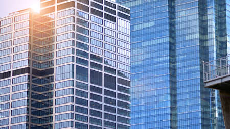 Modern office building detail, glass surface on a clear sky background. Transparent glass wall of...