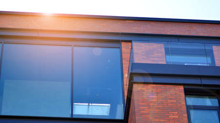 Architectural exterior detail of residential apartment building with brick facade. Modern brick and...