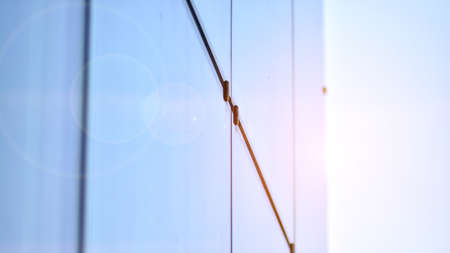 Modern architecture with sun ray. Glass and steel facade on a bright sunny day with sunbeams on the...