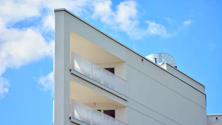Condominium and apartment building with symmetrical modern architecture in the city downtown.