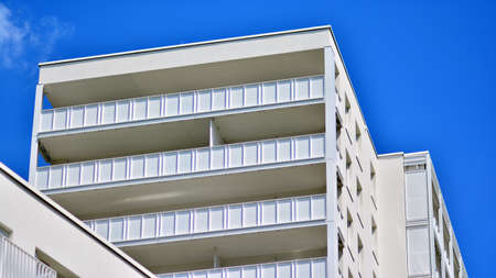 Condominium and apartment building with symmetrical modern architecture in the city downtown.