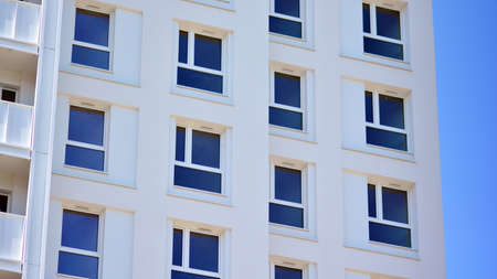 Condominium and apartment building with symmetrical modern architecture in the city downtown.