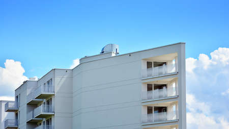 Condominium and apartment building with symmetrical modern architecture in the city downtown.