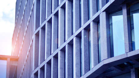 Abstract image of looking up at modern glass and concrete building. Architectural exterior detail of...
