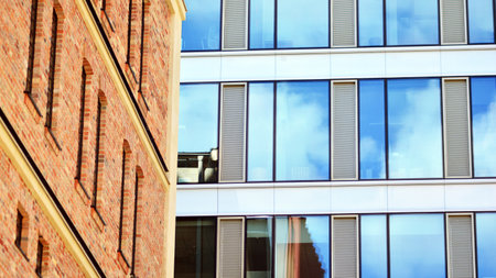 Revitalized red brick building and modern office building. Rising sun on the horizon.