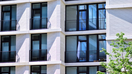Detail in modern residential flat apartment building exterior. Condominium and apartment building with symmetrical modern architecture.の写真素材