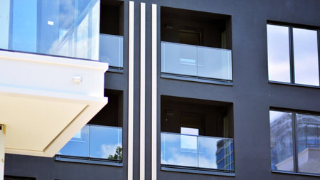 Detail in modern residential flat apartment building exterior. Condominium and apartment building with symmetrical modern architecture.の写真素材