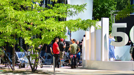Warsaw, Poland. 14 June 2021. Busy outdoor filming production crew team. Work on an advertising...