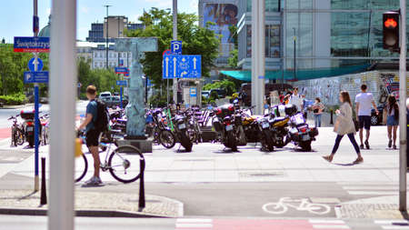 Warsaw, Poland. 14 June 2021. Streets and pavements in the center of Warsaw. The pedestrian crossing against the background of a summer green park.のeditorial素材