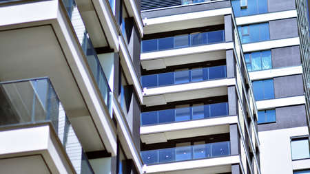 Condominium and apartment building with symmetrical modern architecture in the city downtown.