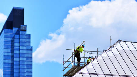 Construction workers on a scaffold.