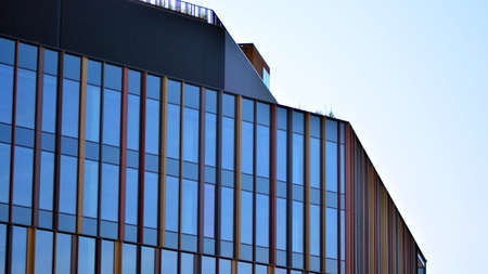 Abstract closeup of the glass-clad facade of a modern building covered in reflective plate glass....