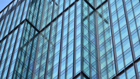 The glazed facade of an office building with reflected sky. Modern architecture buildings exterior