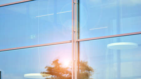 The glazed facade of an office building with reflected sky. Modern architecture buildings exterior