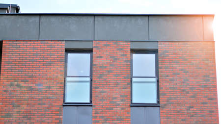 Modern apartment buildings on a sunny day with a blue sky. Facade of a modern apartment building....