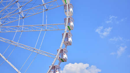 Szczecin, Poland .. 24 July 2021. Amusement park with recreational equipment and other entertainment facilities. Ferris wheel on a sunny day.のeditorial素材
