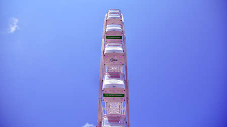 Szczecin, Poland .. 24 July 2021. Amusement park with recreational equipment and other entertainment facilities. Ferris wheel on a sunny day.のeditorial素材