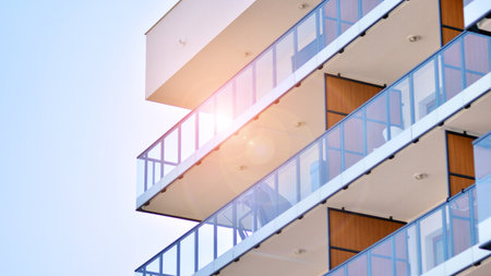 New apartment building with glass balconies. Modern architecture houses by the sea. Large glazing on the facade of the building.の写真素材