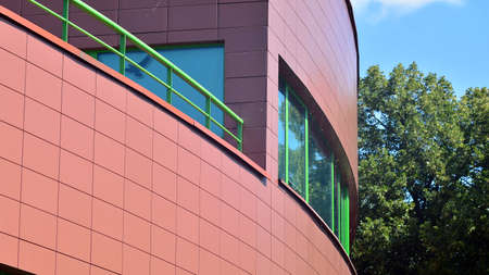 Modern glass office building with green leaves. Eco building and greens plants in city concept.