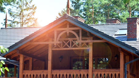 Eco architecture. Green trees and old single family building in forest. The harmony of nature and...