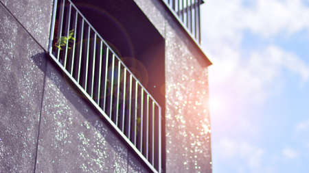 Modern apartment building on a sunny day with a blue sky. Facade of a modern apartment building.Glass surface with sunlight.の写真素材
