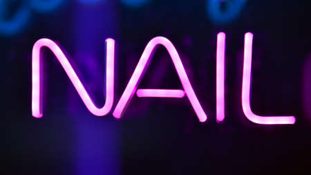 Glowing fragment of a neon sign, close-up, abstract background