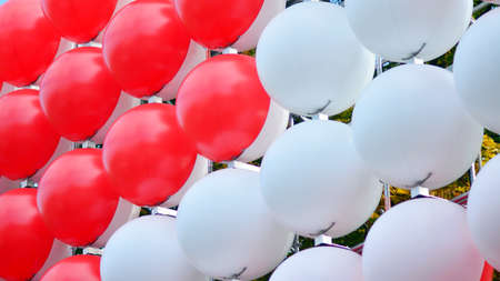 An fragment of Swiss flag made of red and white balloons