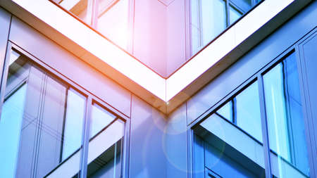 Modern office building with glass facade on a clear sky background. Transparent glass wall of office...