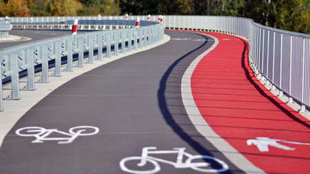 Bicycle path and sidewalk through the highway bridge.の写真素材