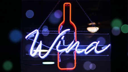 Glowing fragment of a neon sign, close-up, abstract background. Bokeh light flare.の写真素材
