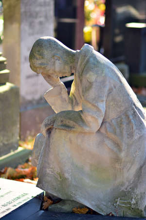 Warsaw, Poland. 1 November 2021. Stone figure of an old grave on a Powazki Cemetery.Old Powazki is historic cemetery in Wola District of Warsaw city.のeditorial素材