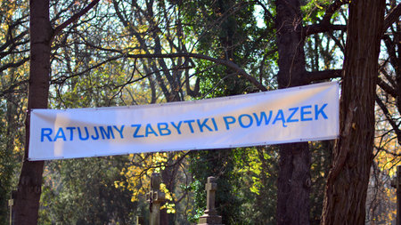 Warsaw, Poland. 1 November 2021. Old Powazki is historic cemetery in Wola District of Warsaw city. Tombstones and trees at the old cemetery. All Saints Day. Sign Let's save the monuments of Powazki.のeditorial素材