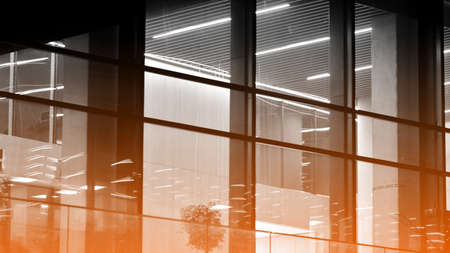 Skyscraper lobby in business district. Big glass windows in commercial skyscraper at night. Black...