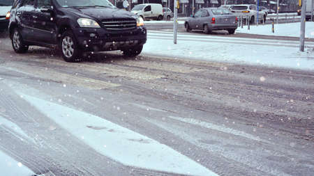 Car in winter during a snowfall on the road.の写真素材