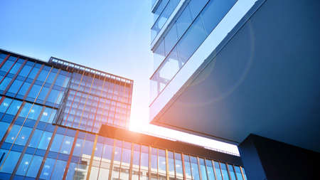 View of an modern apartment building standing next to a new modern office building with a glass...