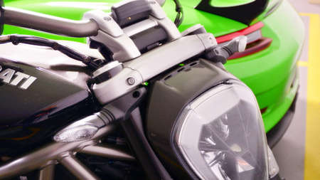 Warsaw, Poland. 8 February 2022. Green Porsche 911 GT3 RS sports car and black Ducati XDiavel S...
