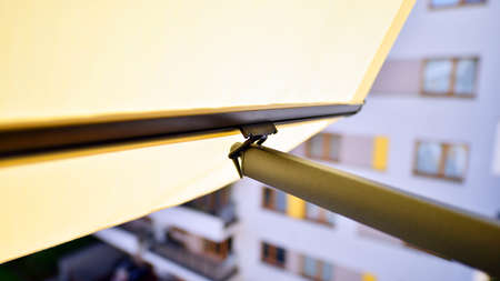 Modern architecture building facade with awnings. Balcony with awning opened, covered by sun-shield.の写真素材