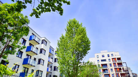 Ecological housing architecture. A modern residential building in the vicinity of trees. Ecology and...