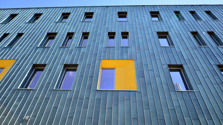 Fragment of modern urban geometry. Walls office building made of steel and glass.