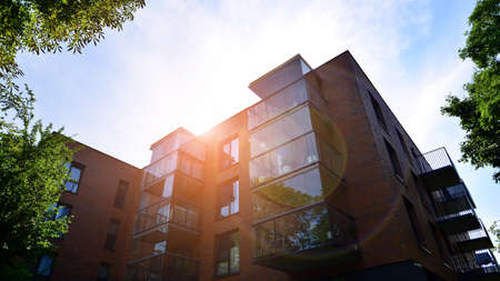 Modern luxury residential flat. Modern apartment building on a sunny day. Apartment building with a blue sky. Facade of a modern apartment building.の写真素材