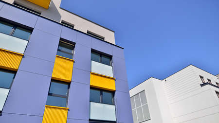 Exterior of new apartment buildings on a blue cloudy sky background. No people. Real estate business...